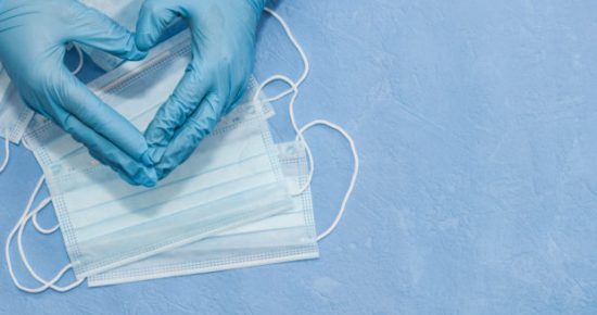 Protective medical white face mask on a blue background. View from above. Virus Prevention Space for text. Close up